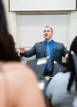 A music professor conducts a choir at Marietta College