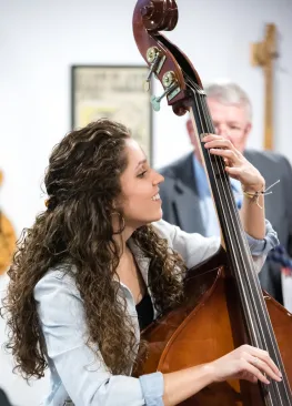 A Marietta College Music Therapy major playing a standup bass.