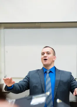 Professor Jay Dougherty leads the choir in song