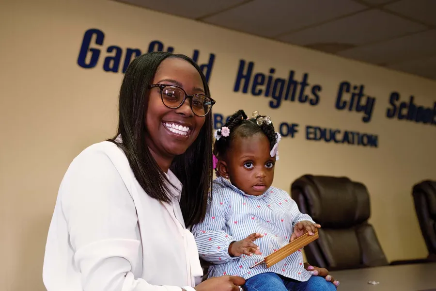 Ashley Thomas poses with a child