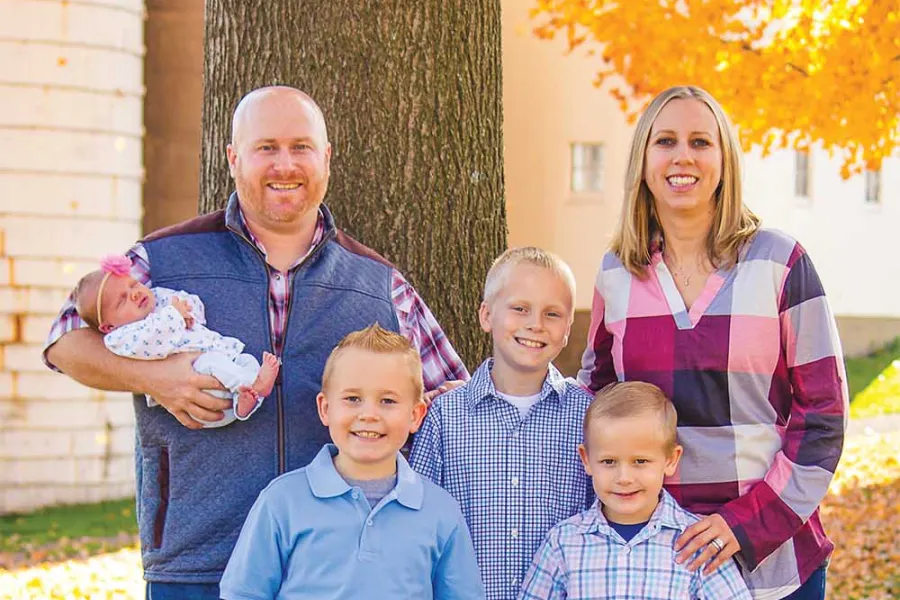 Hofsinger family poses in front of a tree