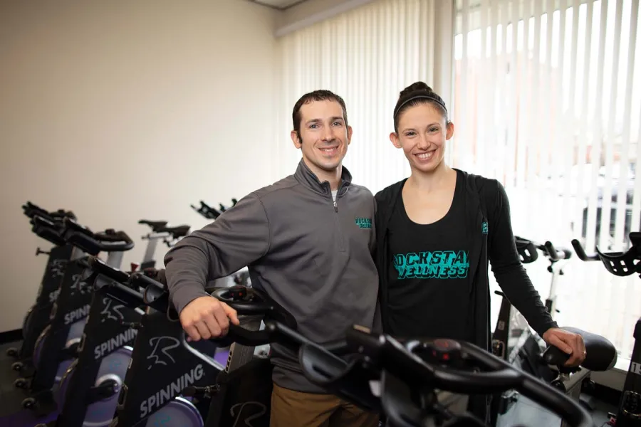 The Burnhams posing with their spin bikes