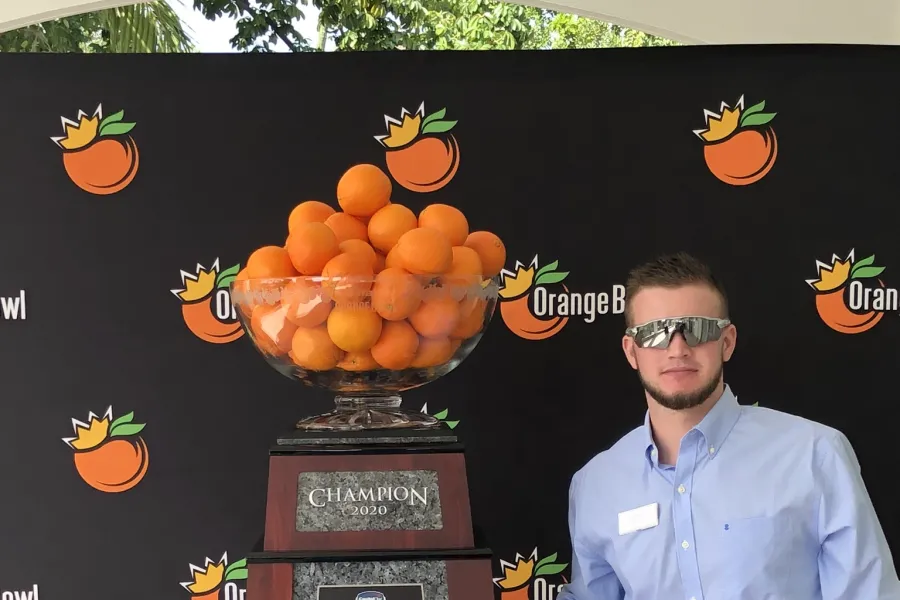 Josh Pennington ’21 with the Orange Bowl trophy
