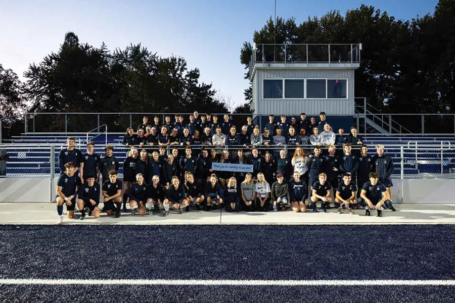 Group photo of players from Marietta College's Mens and Womens Soccer and Womens Lacrosse in front of the new bleacher