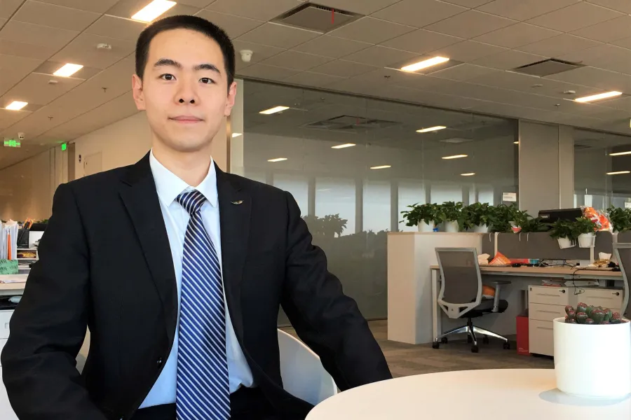 Xingyu Chen sitting at a table