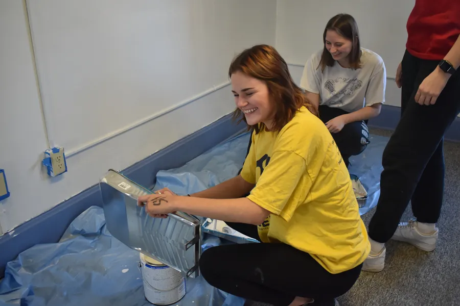 Volunteers painting inside Big Blue Thrift Store during the Martin Luther King, Jr. Day of Service