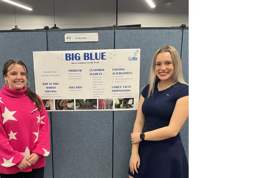 Big Blue co-founders Alexis and Lilly present their poster during PioBiz