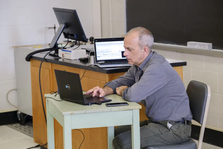 Dr. David Brown sits at a computer desk